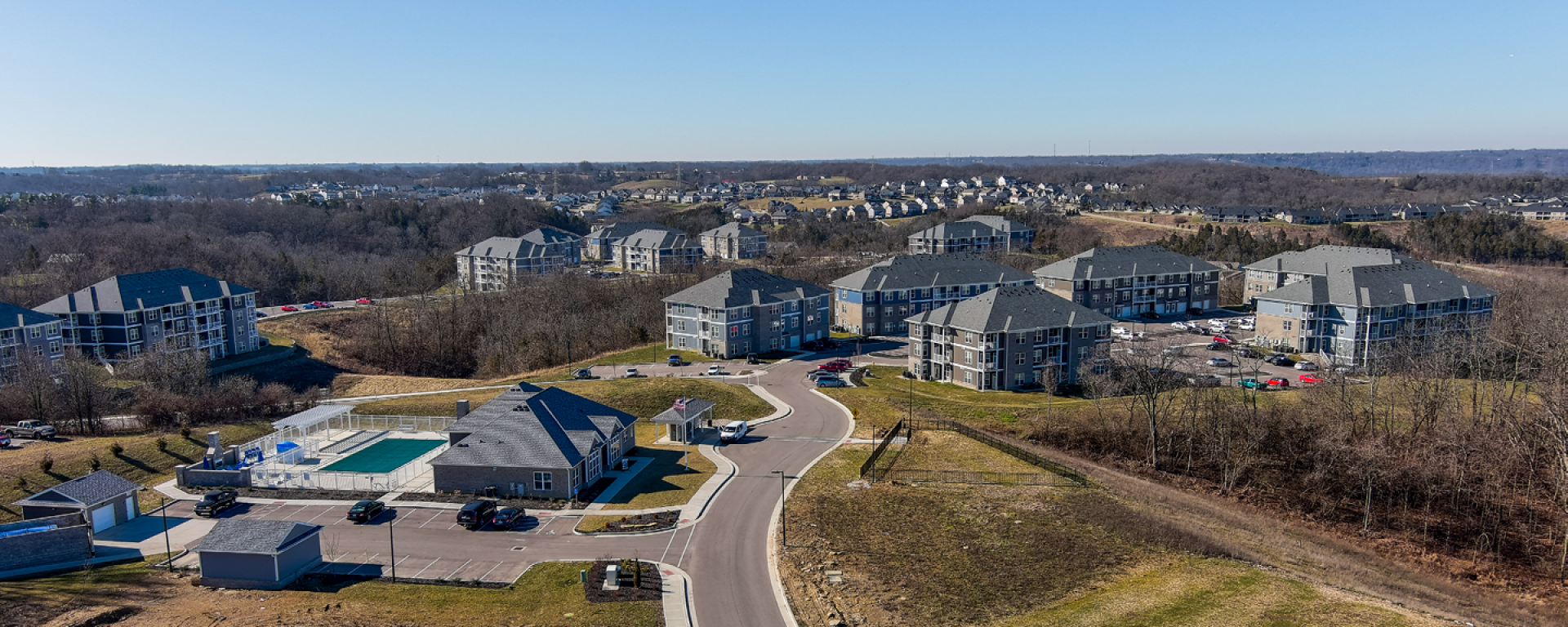 aerial photo of apartment buildings on a hill with a road