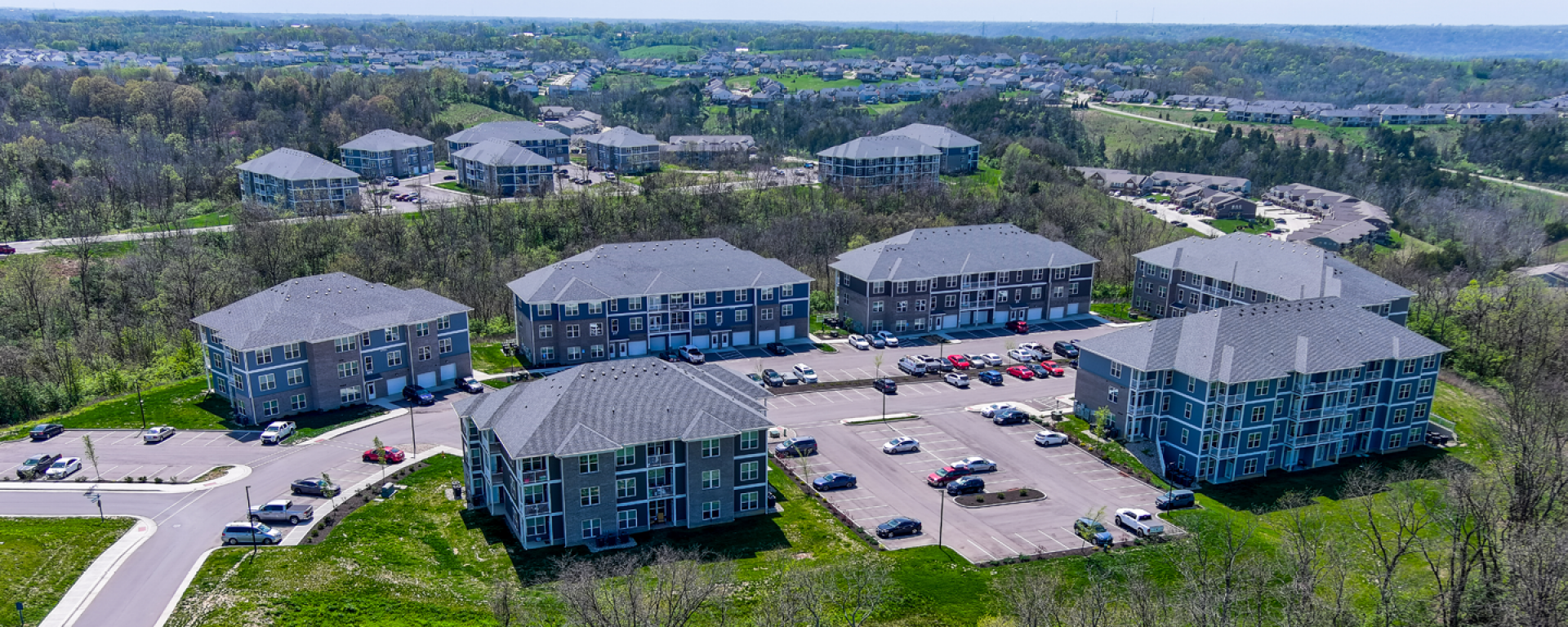 aerial photo of apartment buildings on green grass