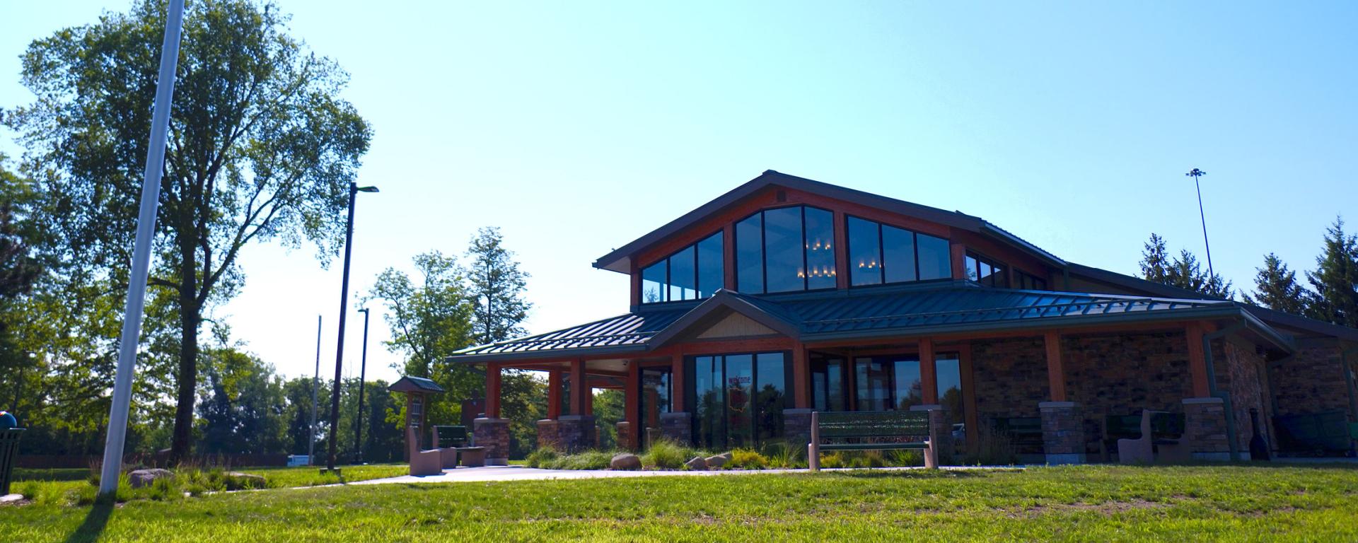 green grass and wood and stone building