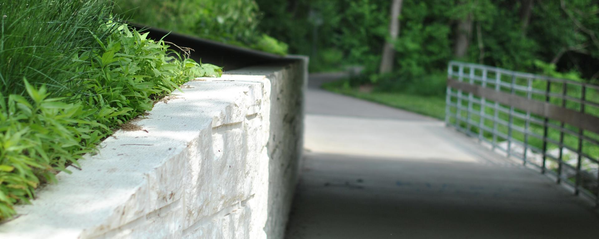 park trail with stone wall