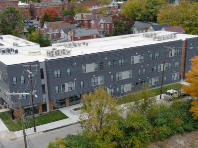 Aerial photo of a gray apartment building in urban neighborhood