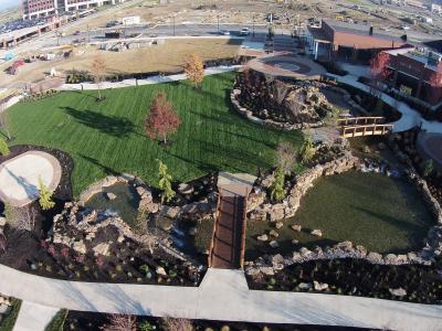 aerial image of park featuring pond 